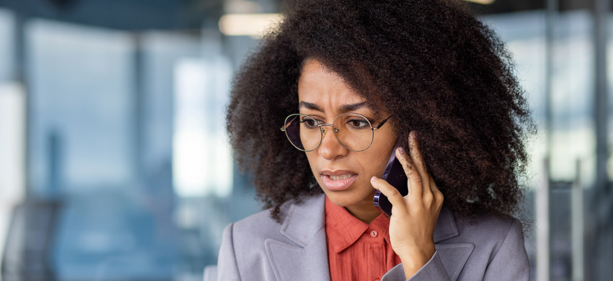 concerned-woman-talking-on-mobile-phone-indoors